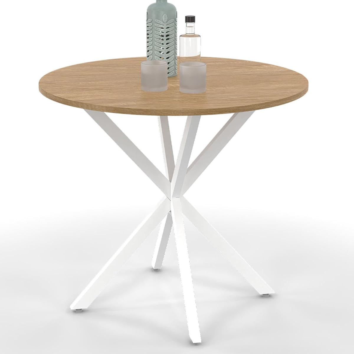 Table ronde Alix à plateau effet bois et pied araignée blanc dans une salle à manger lumineuse.