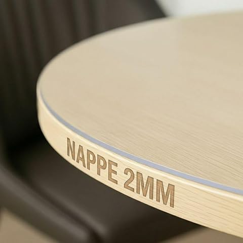 Nappe ronde transparente en PVC posée sur une table à manger en bois clair
