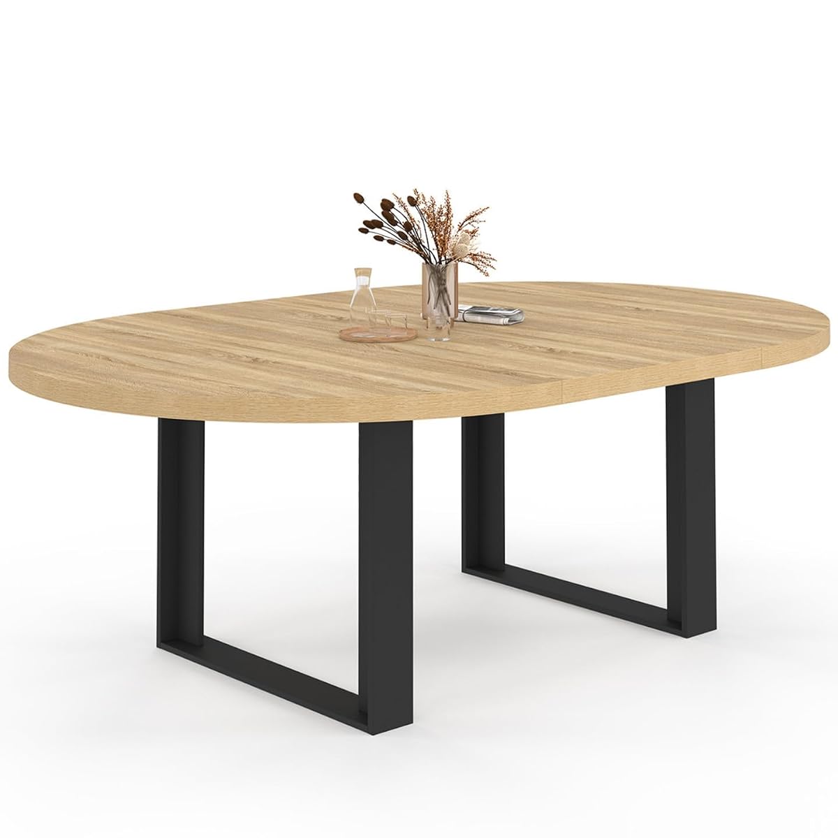 Table ronde extensible Phoenix noire, avec plateau épais et larges pieds, dans un intérieur lumineux
