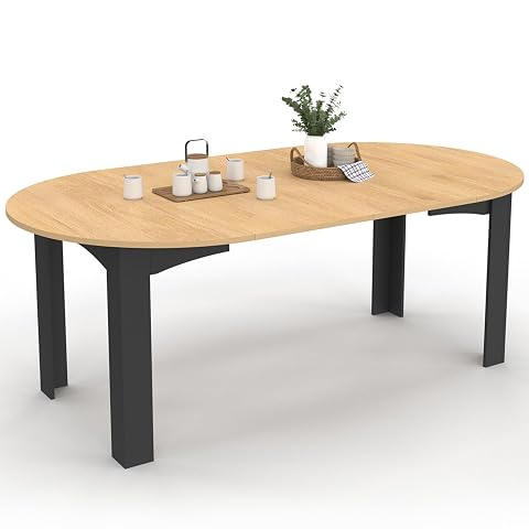 Table Dona extensible, plateau façon hêtre et larges pieds noirs dans un intérieur lumineux.