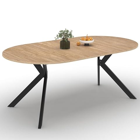 Table Alix extensible au plateau bois et pied araignée noir, présentée dans un intérieur lumineux