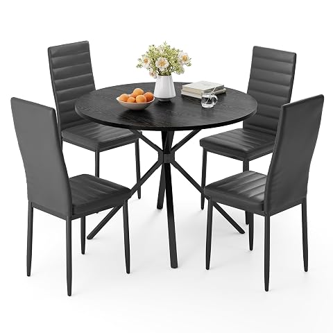 Table ronde noire avec piètement en X et quatre chaises rembourrées assorties