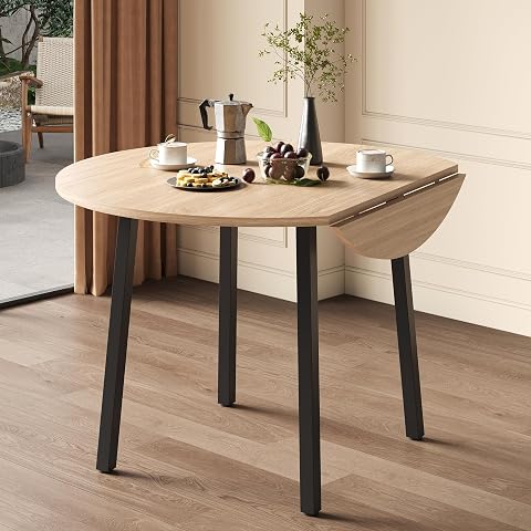 Table ronde pliante Merax à plateau aspect bois et pieds en métal dans un intérieur lumineux