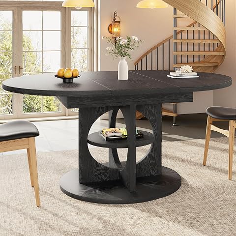 Table à manger noire extensible en format ovale, avec étagère traversante dans le pied central.